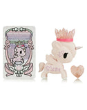The tokidoki Precious Unicorno - Pink Aura Amethyst (Special Edition) features a pink unicorn figurine with a crystal crown, a heart-shaped gem, and a