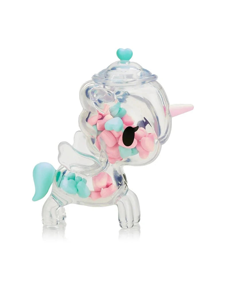 The tokidoki Sugar Shop Unicorno Blind Box features a clear unicorn-shaped container filled with pastel pink, blue, and green heart candies—a sweet collectible displayed against a white background.