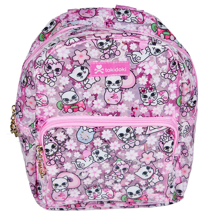 The tokidoki Cherry Blossom Cats Clear Backpack features a pink design, clear covering, cartoon cat and cherry blossom patterns, and a front zipper pocket.