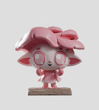 A Capkins — Series 2 Blind Box vinyl toy from Kaleidos Creative, featuring a pink cat-like figure with large ears and flower-shaped hair on a textured base, stands against a gray background.