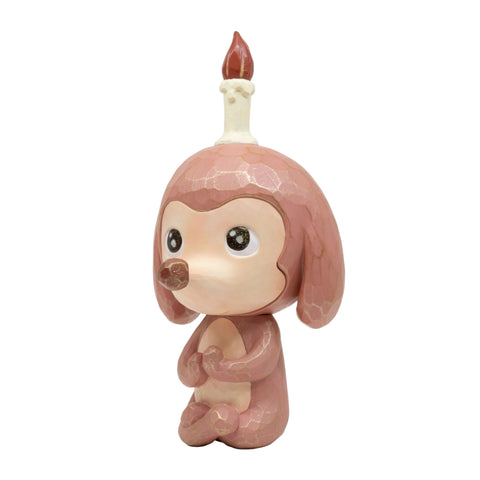 Keep Balance Version 2 by How2Work features a pink, cartoon-inspired dog figurine sitting upright with a long candle atop its head, complete with a red flame. The whimsical dog has large eyes, floppy ears, and a round nose. Inspired by Chen Wei Ting’s playful designs, this charming piece serves as a gentle reminder to maintain balance in your daily life.