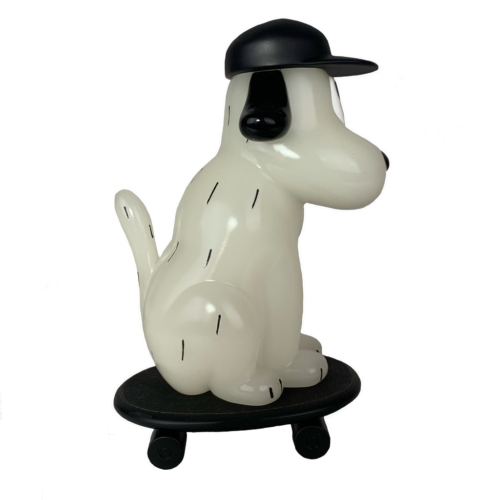 The One-Chu SK8 - Glow by How2Work features a stylized white dog with black ears and cap on a black skateboard, complete with glow-in-the-dark details.