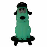 The One-Chu SK8 - Glow by How2Work features a green cartoon dog figure in a black cap sitting on a skateboard-like black platform, set against a white background.
