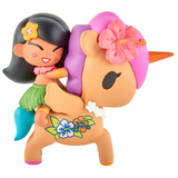 The tokidoki Hawaiian Ohana Blind Box features a cute cartoon-style figurine of a girl in a hula outfit riding a tan unicorn with a pink mane and floral accents—ideal for tropical collectors and tokidoki fans.
