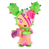 A vibrant vinyl figure from the tokidoki Hawaiian Ohana Blind Box features green cactus-like ears, pink floral accents, a pink-and-yellow dress, and a purple accessory—an ideal tropical collectible from tokidoki.