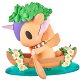 A tokidoki Hawaiian Ohana Blind Box figurine paddles a flower-adorned boat on blue water, making an adorable addition to any tokidoki collection.