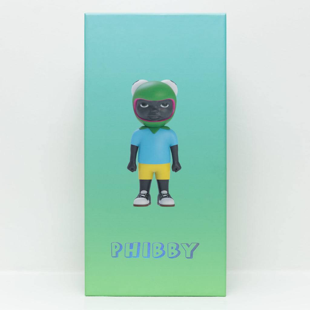 A box with a green-to-blue gradient background displays Phibby — OG (Green), a 12-inch limited edition vinyl collectible by Hebru Brand, showing the toy figure in a green helmet, blue shirt, yellow shorts, and sneakers.
