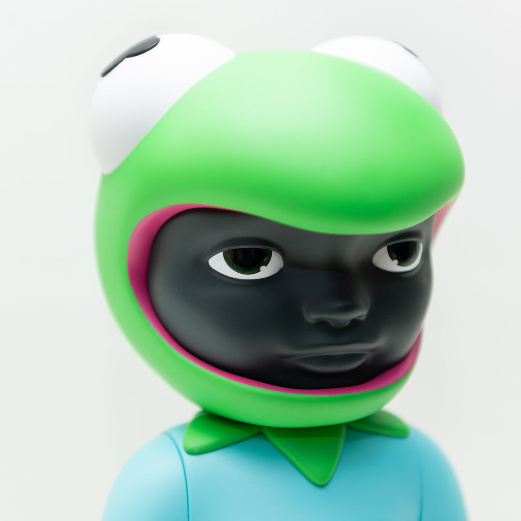 Phibby — OG (Green) by Hebru Brand is a limited edition 12-inch vinyl figure with a large green frog-like head, wide eyes, black face inside the mouth, and blue outfit with green collar—an iconic collectible from Hebru Brantley.
