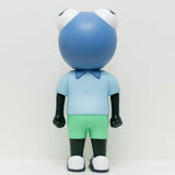 Phibby — Purple by Hebru Brand is a cartoonish frog vinyl figure with a large blue head, big white eyes, a light blue shirt, and green shorts, standing against a plain white background.