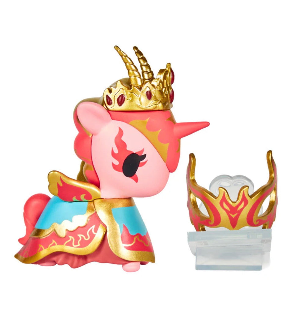 A pink tokidoki Unicorno After Dark Masquerade Blind Box figure with a gold crown and armor stands beside a matching accessory on a clear base—an ideal addition to any surprise collectible collection.