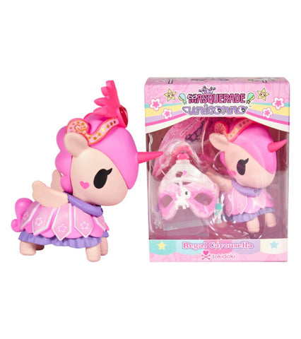 A pink and purple Unicorno After Dark Masquerade - Regal Carousella (Special Edition) toy with a crown and mask stands by its box, branded tokidoki.