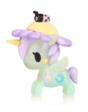 A tokidoki Flower Power Unicorno Series 2 - Daisy (Special Edition) toy figure of a green unicorn with purple mane, tail, and horn, adorned with flower decorations, with a small figure of a ladybug on its back.