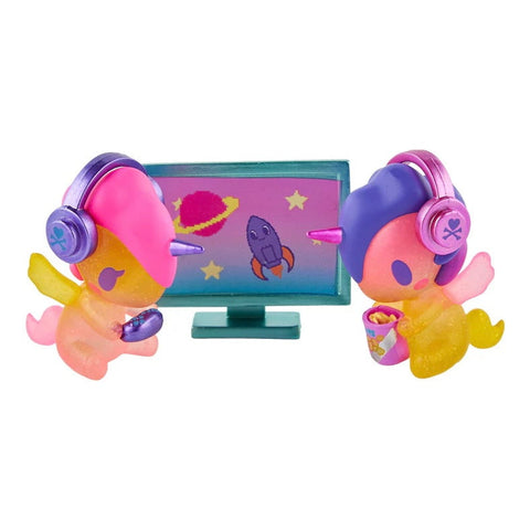 Tokidoki Twinsies Unicorno - Gamer & Streamer (Special Edition) by tokidoki features a colorful duo with headphones, watching a rocket-filled space scene; one holds popcorn and the other a game controllerβperfect for fans!.