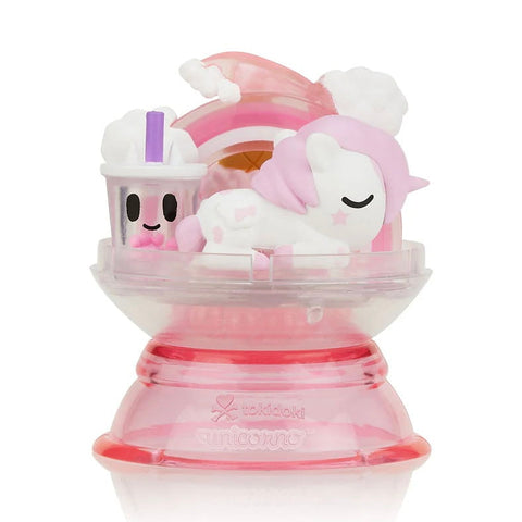 The Tokidoki Dreaming Unicorno - Strawberry Milk (Special Edition) by tokidoki features a pink and white unicorn with a milkshake, rainbow background, and clear pink baseβan adorable collectible for any unicorn fan.