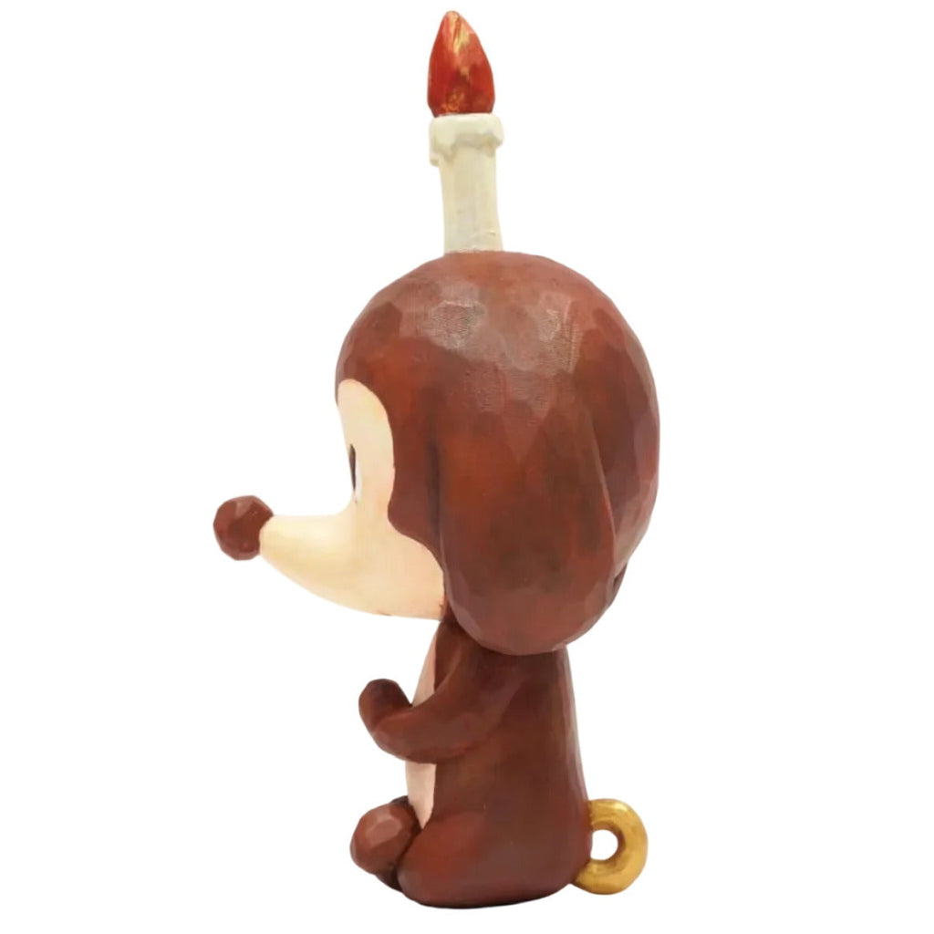 Keep Balance by How2Work is a brown cartoon monkey relaxation figure with a white belly, small tail, and candle on its head—displayed in profile, it adds a charming and balanced touch to your home decor.