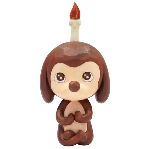 Keep Balance by How2Work is a brown cartoon animal figurine with large eyes, sitting upright and featuring a candle with a red flame on its head—a perfect touch for balanced, relaxing home decor.