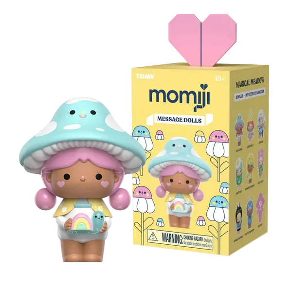 The Momiji Magical Meadow Message Dolls Blind Box features a collectible doll with a mushroom hat and pastel colors beside its illustrated yellow box, making it perfect for fans of whimsical charm and magical dolls.