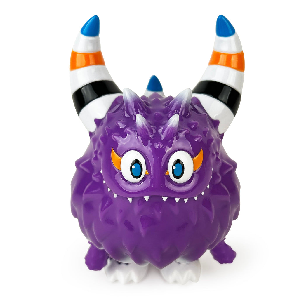 Rangeas Rex Jr. — Lollipop Purple by The Little Hut is a purple, spiky toy monster with two striped horns, big blue eyes, small fangs, a grumpy face, and four white feet.