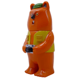 Mamechan - #1 by Paradise Toy is an orange bear figurine with a yellow vest, green hat, and camera, standing upright against a white background—a delightful piece for any tourist collectible collection.