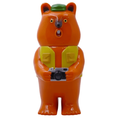 Mamechan - #1 by Paradise Toy: a plastic bear figurine standing upright, wearing a green hat and yellow vest, holding a camera with a surprised look—an ideal tourist collectible for your collection.