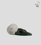A minimalist figurine from the Kaleidos Creative Meyanmi Shadow Blind Box lies under a dark blanket, hinting at a blind box surprise. A