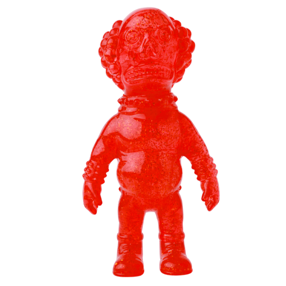The VAG 36 - Deadman by Medicom is a red translucent Japanese vinyl toy with an oversized head, curly hair, and a spacesuit-inspired outfit, standing facing forward.