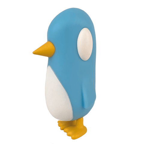 The Old Friend — Blue Skies figurine from Strangecat Toys is a blue, cartoon penguin with yellow beak and feet, standing upright against a white background.