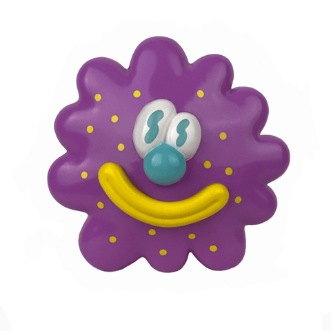 The Partner Toys Virus Flower is a playful, flower-inspired purple spiky circular toy with yellow dots, a big yellow smile, blue nose, and cartoon eyes. It measures 3.5 inches across and resembles a cheerful virus flower.