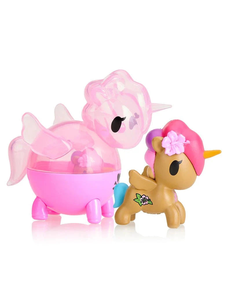 Discover two adorable figures from the tokidoki Unicorno Capsule Cuties Blind Box: a translucent pink unicorn with wings and wheels, and a brown unicorn with a yellow horn, pink mane, and floral details—perfect for any Unicorno fan!.