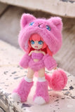 A ball-jointed doll with pink hair in a fluffy pink cat costume, including ears, mittens, boots, and tail, stands on a weathered stone. This adorable figure is from the BIJIDI Cat Island — Black Cat Or Candy Cat? blind box collection.