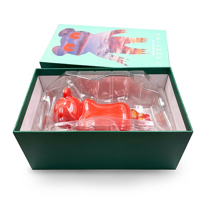 The Creeping Dero — Original is a red designer vinyl figure by Jermaine Rogers, shaped like an animal and packaged in a green box with CREEPING and illustrated animal art on the lid, lying in a clear plastic mold inside.