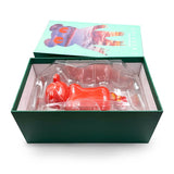 The Creeping Dero — Original is a red designer vinyl figure by Jermaine Rogers, shaped like an animal and packaged in a green box with CREEPING and illustrated animal art on the lid, lying in a clear plastic mold inside.