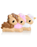 Three tokidoki Toki Mochi Donut Unicorno Blind Bag figures in ice cream-inspired brown, pink, and white designs with sprinkles are lined up side by side on a white background.