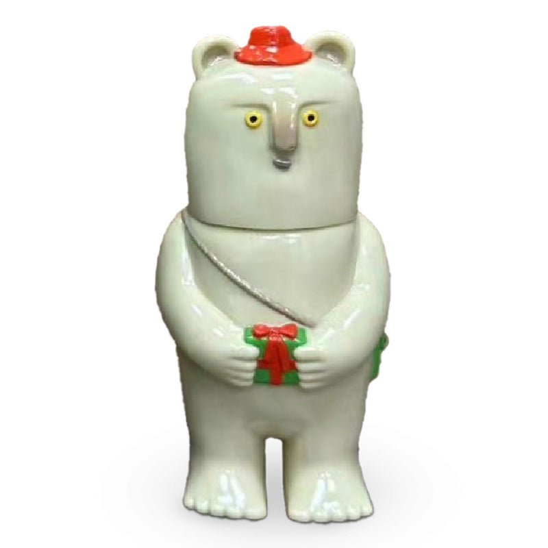 The Kurichan — Christmas 2023 by Paradise Toy is a ceramic bear figurine with yellow eyes, a red hat, a green bag, and holds a small green and red gift.