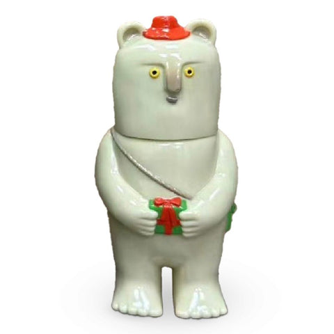 The Kurichan — Christmas 2023 by Paradise Toy is a ceramic bear figurine with yellow eyes, a red hat, a green bag, and holds a small green and red gift.
