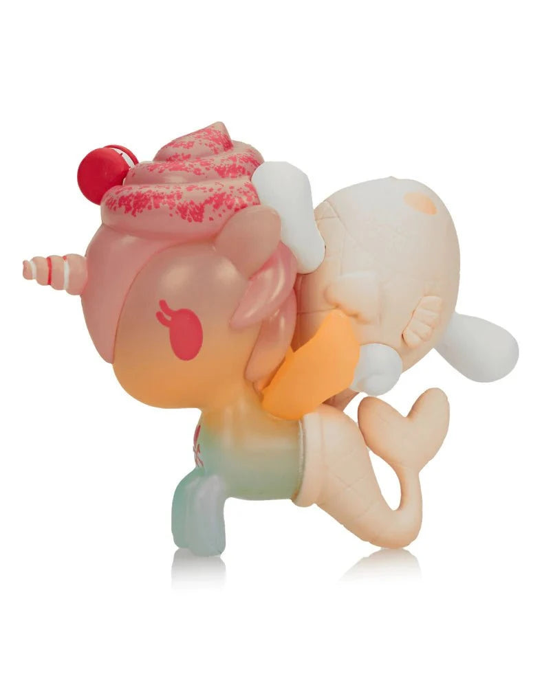 The tokidoki x Cinnamoroll Sweet Treats - Cinnamoroll x Mango'licious (Special Edition) is a pastel figurine featuring a unicorn-mermaid design, with donut and whale tail details, inspired by tokidoki’s signature Sweet Treats style.