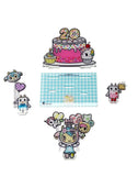 The tokidoki 20th Anniversary Acrylic Standee Blind Box features cute cartoon animals, a cake with “20” candles, and character accessories on a blue checkered base—all celebrating tokidoki's 20th anniversary.
