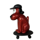 The How2Work One-Chu Sk8 - Red Glitter features a red glittery dog figure in a black cap, sitting on an 8-inch collectible red skateboard with wheels, shown against a white background.
