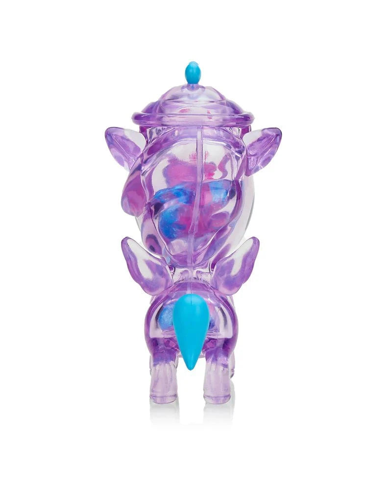 A translucent purple figurine with wings, blue tail, and blue-tipped lid on its head, the tokidoki Sugar Shop Unicorno - Very Berry (Special Edition) is photographed against a white background.