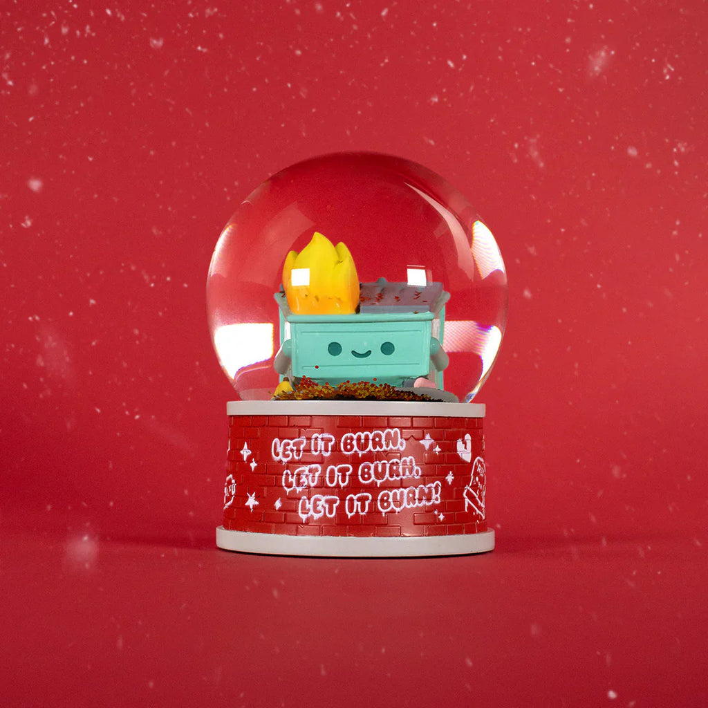 The 100% Soft Dumpster Fire Snow Globe shows a smiling dumpster with cartoon flames inside, snow-like specks, and a base that says