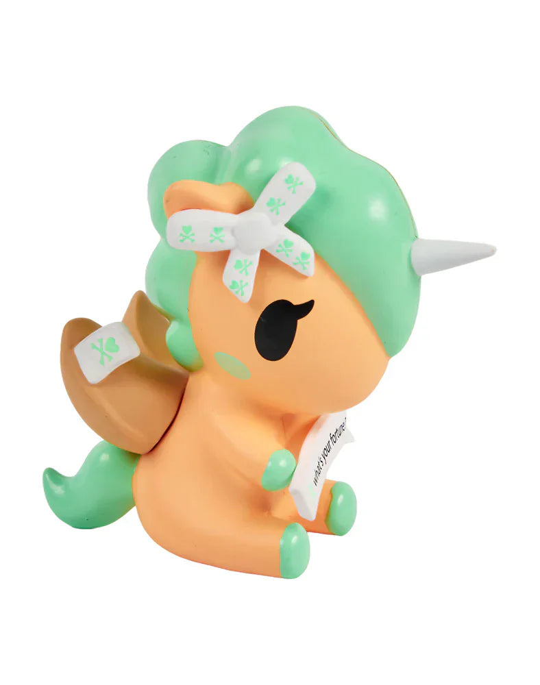 The tokidoki Fortune Cookie Unicorno Blind Box features a small orange and mint green unicorn figure with a white horn, winged saddle, bandage bow, and scroll—perfect for any Blind Box collection.
