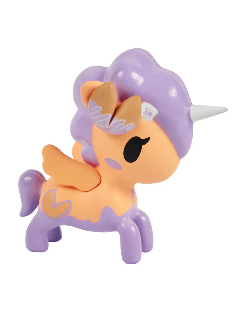 The Fortune Cookie Unicorno Blind Box by tokidoki features a small unicorn toy with a light orange body, lavender mane, tail, and wings, plus a silver horn. A surprise figure perfect for collectors! Displayed on a white background.