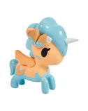 The tokidoki Fortune Cookie Unicorno Blind Box features a small toy unicorn with blue and orange details, orange wings, white horn, and blue bow—perfect as a surprise collectible figure against a white background.