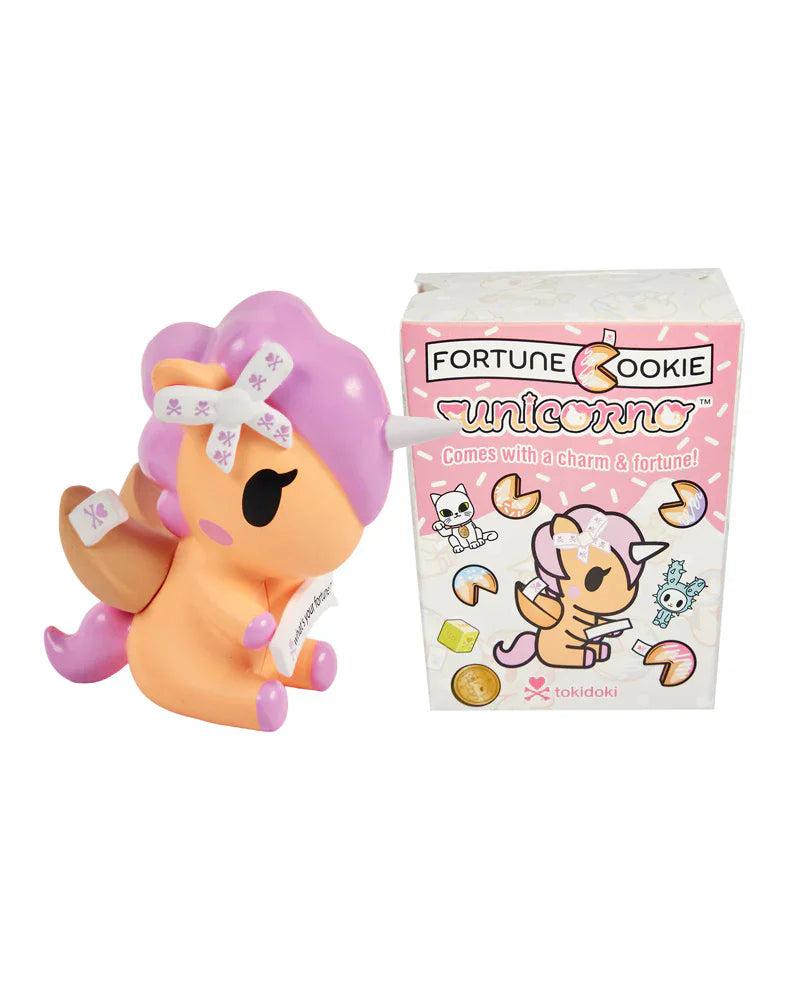 A toy unicorn with a fortune cookie theme is displayed beside the pink
