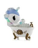 The tokidoki Spa Day Unicorno Blind Box features a pastel Unicorno relaxing in a white clawfoot tub with gold accents and bubbles, creating an adorable kawaii wellness scene.