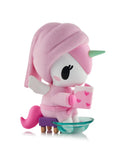 The Spa Day Unicorno Blind Box by tokidoki features a kawaii figurine with a pink mane and towel, relaxing in a clear tub with a heart-covered pink book—perfect for adding wellness charm to any collection!.