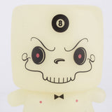 The limited edition Grim Marshall by 64 Colors from Squibbles Ink + Rotofugi is a vinyl toy with a square head, cartoonish angry face, black bow tie, and 8-ball on its forehead—perfect for collectors.
