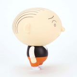 Side view of the Presspop Jimmy Corrigan Vital Animus Vinyl Doll, featuring thin black hairlines, a black vest, white shirt, orange pants, and white shoes set against a plain white background.