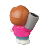 A Medicom Vinyl Artist Gacha Series 13 - Fumharu Kun figure with brown hair, a pink shirt, and blue pants holds a gray cylinder over its shoulder while facing away from the camera.