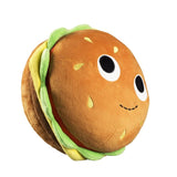 The Kidrobot Bunford Burger - 10 inch Yummy World Plush is a burger-shaped plush toy with lettuce, tomato, cheese details, and features cute cartoon eyes and a smiling mouth.